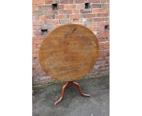 A GEORGIAN MAHOGANY TILT TOP PEDESTAL TABLE, the circular top with original mechanism, raised on a vase turned column and tri