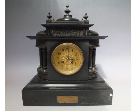 A VICTORIAN BLACK SLATE MANTEL CLOCK, the case of Romanesque form with figural border, the dial with gold painted chapter rin