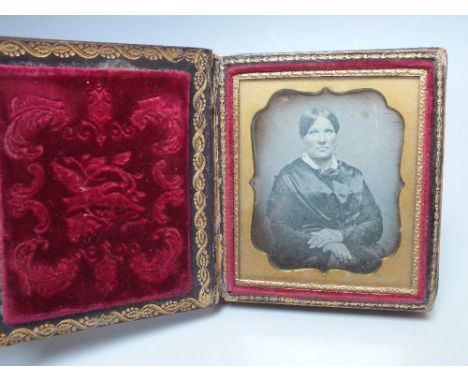 A PAIR OF 19TH CENTURY DAGUERREOTYPE PORTRAIT IMAGES OF HUSBAND AND WIFE, contained in a papier mache case in the form of a b