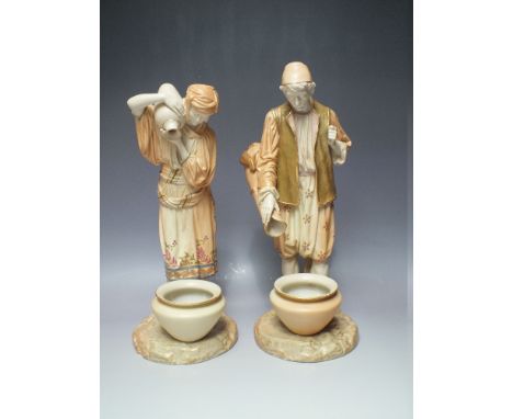 A LARGE PAIR OF ROYAL WORCESTER BLUSH IVORY WATER CARRIER FIGURES, impressed 'Hadley' to the reverse of the female figure, Ro