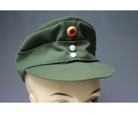 A VINTAGE GERMAN MILITARY CAP, with label to interior