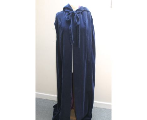 A FULL LENGTH BLUE VELVET HOODED CAPE BY 'RAYMOND OF LONDON', having contrasting purple satin lining, together with a ladies 