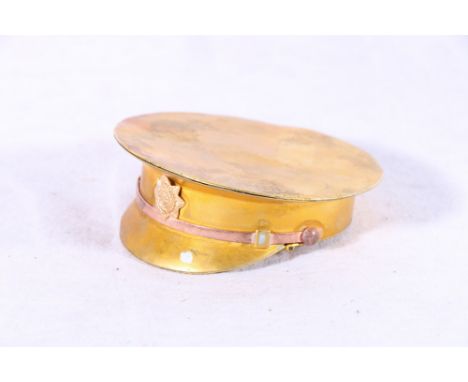 Army Service Corps interest, a gilt metal snuff box in the form of a peaked cap with ASC cap badge, 8cm diameter&nbsp; 