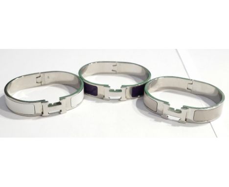 THREE REPLICA HERMES 'CLIC H' BRACELETS
with purple, white and beige enamel (3)