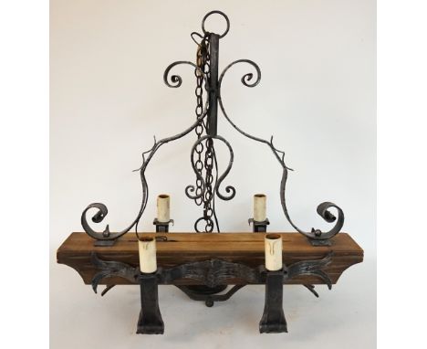 RUSTIC WROUGHT IRON AND MAHOGANY CEILING LIGHT
with a shaped metal and mahogany body with four shaped arms, below a suspensio