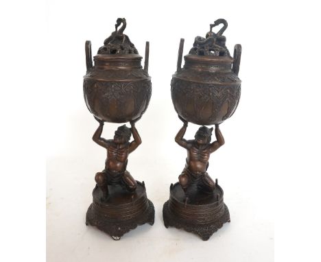 PAIR OF CHINESE BRONZED INCENSE BURNERS
modelled as Diablo holding aloft a large twin handled urn with a pierced lid decorate