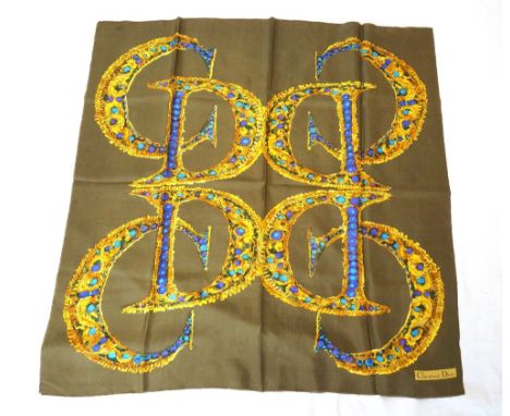 CHRISTIAN DIOR SILK SCARF
with colourful logo decoration on an olive green ground,  79cm x 79cm