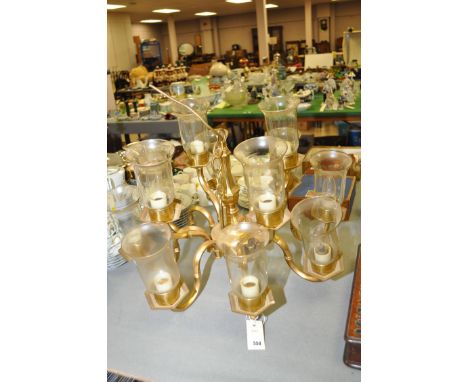 A modern brass twelve-branch electric chandelier with hand-blown glass lamp shades.