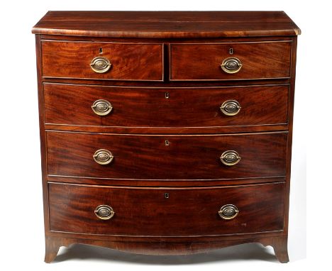 A George III mahogany bowfront chest of two short and three long graduated drawers each fitted embossed brass handles, raised