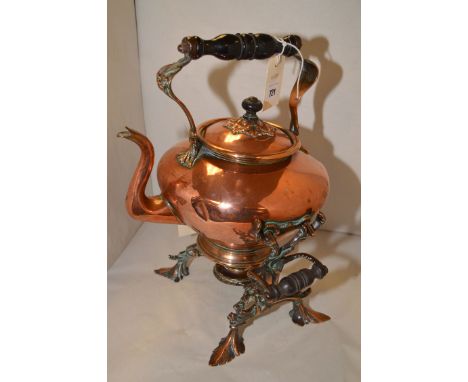 A Victorian copper teapot on ornate burner stand, with turned wooden handle.