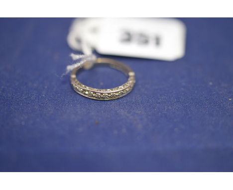 A diamond half hoop eternity ring, set with small diamonds in white metal shank with engraved leaf decorated sides, on 18ct. 