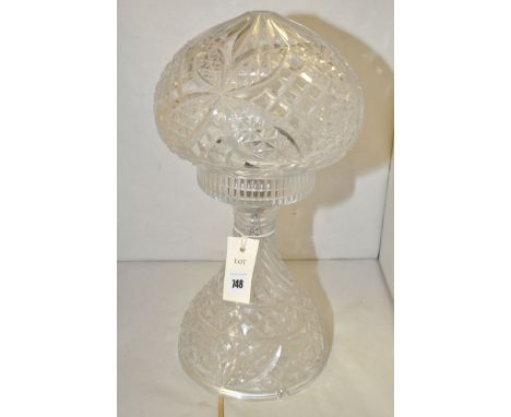 A cut glass table lamp with hobnail cut design.