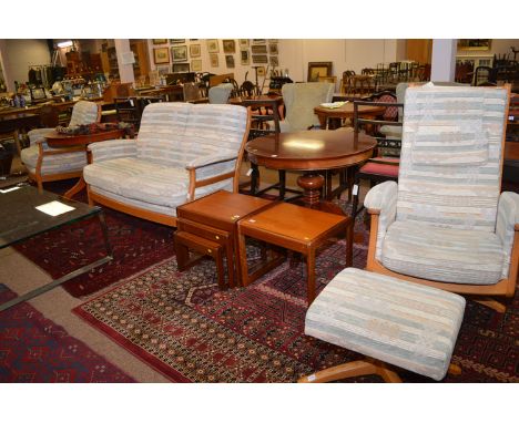 An Ercol sitting room suite comprising: two seater settee, armchair, swivel chair, and footstool, upholstered in stripped mat