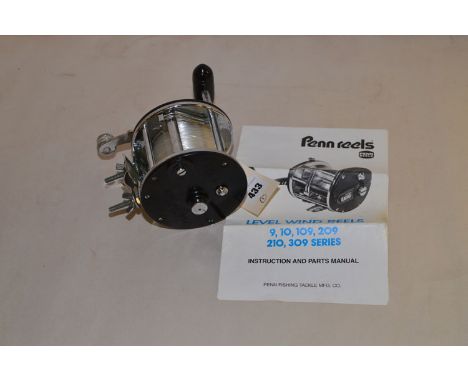 A Penn no.309 multiplying reel in black and chrome finish with instruction leaflet.