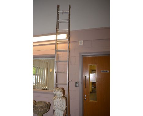 An aluminium extending ladder in two sections.