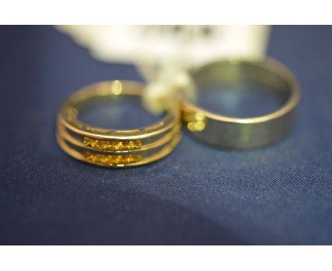 A citrine and 9ct. yellow gold dress ring; and a 9ct. white gold wedding band, 7.7grms gross.