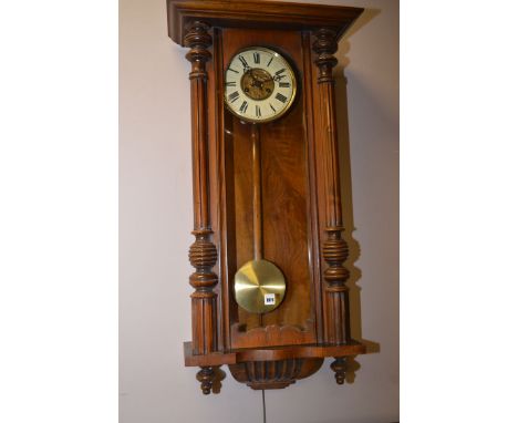 A Victorian walnut Vienna style wall clock, carved horse and mask cornice, above enamel roman dial.