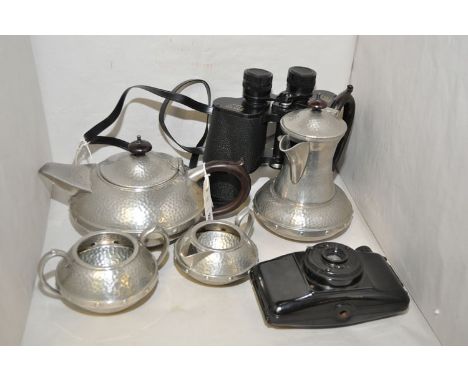 An Arts & Crafts style pewter four-piece tea set, by Craftsman, Sheffield; together with binoculars by Mark, Scheffel; and a 