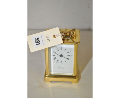 A Woodford brass cased carriage clock with bevelled glass panels.