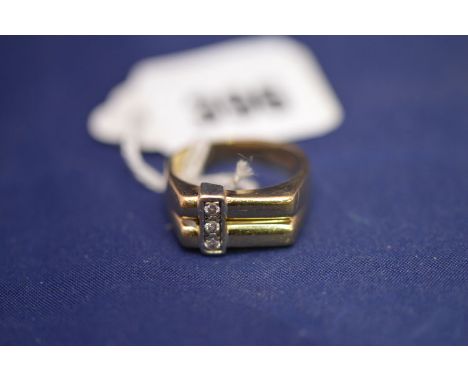 A three stone diamond and 9ct. yellow gold gent's dress ring of geometric form, 7.2grms gross.