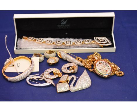 Swarovski jewellery, to include: a bracelet with matching brooch, cased; swan and seashell pattern brooches; bangle; locket a