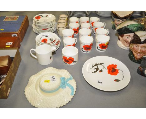 A Wedgwood 'Cornpoppy' pattern part coffee and tea service, designed by Susie Cooper; two mugs and a cream jug 'Bizarre' patt