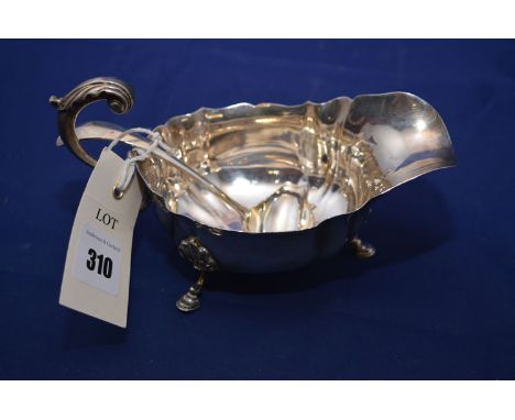 A George V silver sauce boat, by S. Blanckensee & Son Ltd., Chester 1911; and a George V silver sauce ladle, by Robert & Dore