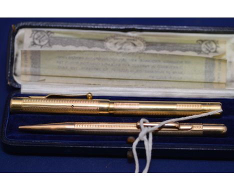 Mabie Todd & Co. Ltd: a fountain pen and matching propelling pencil, in gold plated engine turned cases, the fountain pen wit