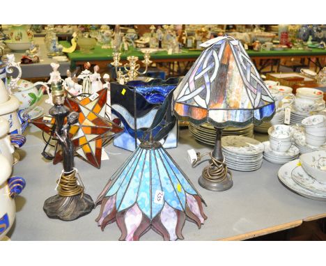 Two Tiffany style table lamps, one with label to underside 'Iona Art Glass, Northumberland'; a star pattern table lamp; and a