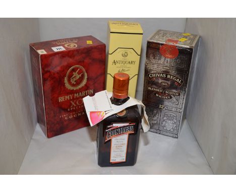A bottle of Chivas Regal Blended Scotch Whisky 12 Year Old; a bottle of Remy Martin Extra Special Fine Champagne Cognac; The 