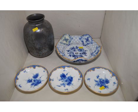 A late 19th Century Meissen onion pattern shaped dish (restored); three Meissen saucers with floral decoration; and a Poole i