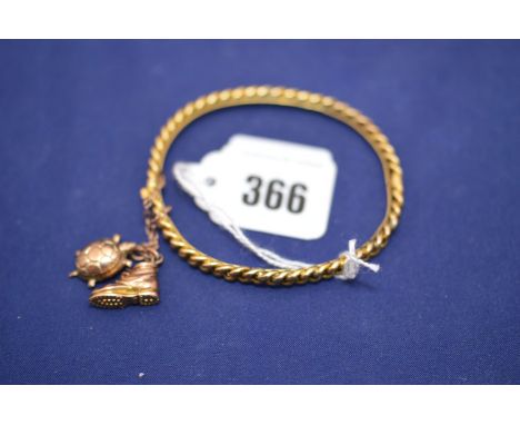 A yellow metal chain link pattern bangle, stamped '15ct.'; and two charms of a boot and a tortoise, one stamped '9ct'.
