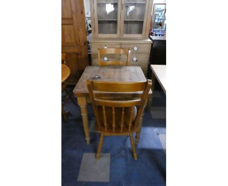 A Square Topped Pine Kitchen Table and Two Spindle Back Kitchen Chairs 