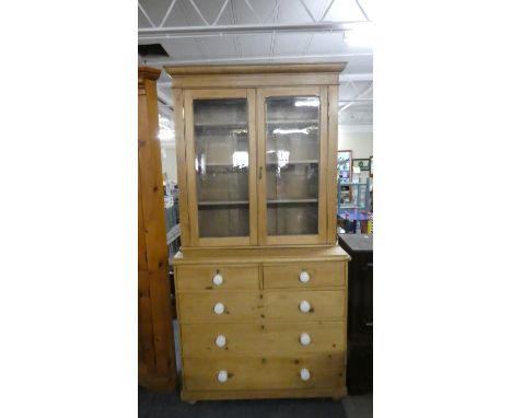 A Pine Chest of Two Short and Three Long Drawers with Ceramic Handles and Unrelated Glazed Bookcase Top, 104cm Wide 