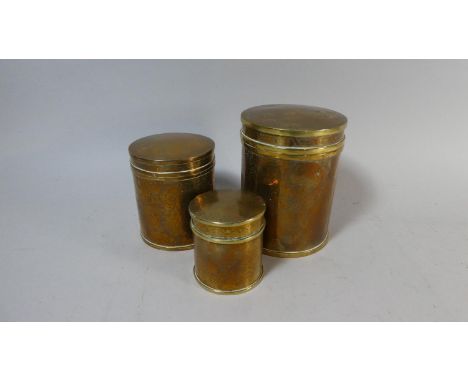 A Set of Three Graduated Oriental Cylindrical Brass Caddy Boxes with Etched Decoration, the Largest 16cm High 