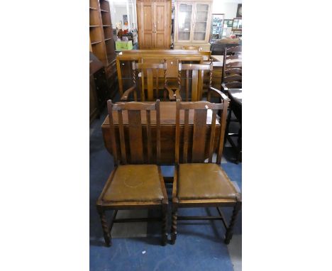 An Oak Gate Leg Drop Leaf Dining Table and Two Pairs of Oak Framed Chairs 