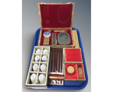 A group of boxed oriental items including set of porcelain bowls, calligraphy set, hand fan, chopsticks, etc.