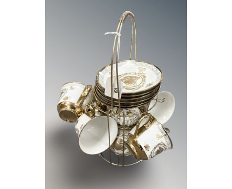A Versace style china tea set on metal two tier stand including teapot, six saucers and five cups