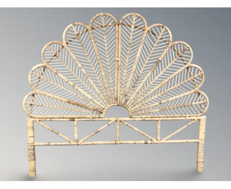 A wicker peacock fan headboard, width 180 cm.
