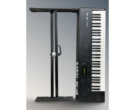 A Kawai K4 16 bit digital synthesizer and a folding keyboard stand. (no lead)