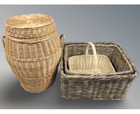 A wicker laundry hamper, height 70 cm, and three various baskets. 
