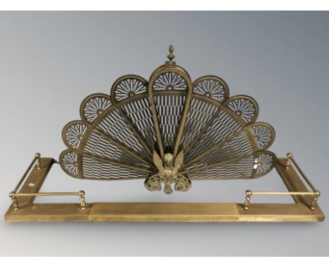 A brass folding "peacock" fire screen, width 96 cm and a telescopic fire curb 