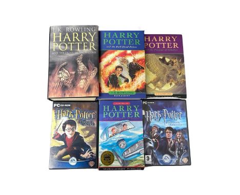 A mixed lot of Harry Potter memorabilia, to include: - Chamer of Secrets, paperback edition - The Prisoner of Azkaban, hardbo