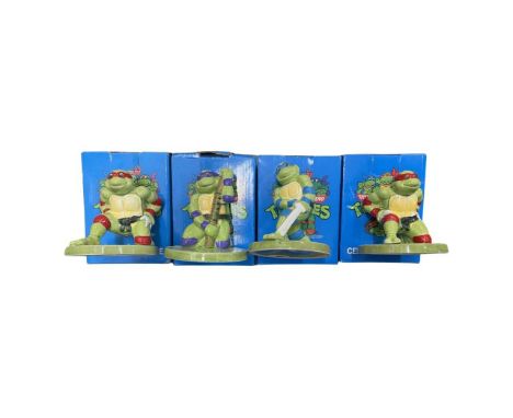 A collection of boxed ceramic Teenage Mutant Ninja Turtles figurines by Harry James