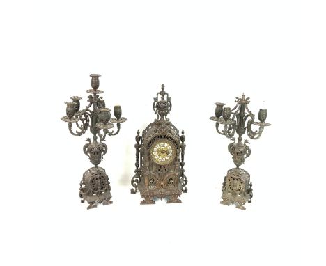 Large bronze ornate table clock of Gothic influence, H57cm; together with a pair of five branch table candelabras. Together w