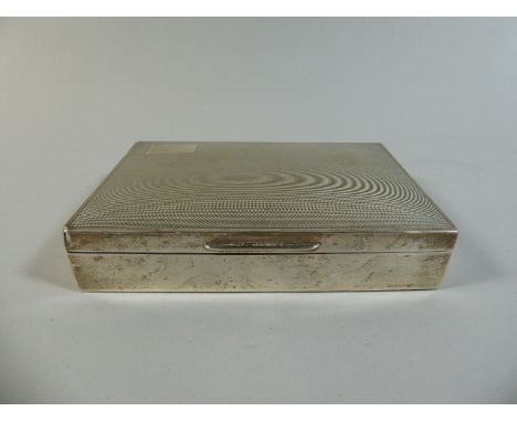 A Silver Cigarette Box with Engine Turned Decoration. Birmingham 1957