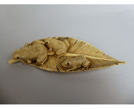 A Signed Japanese Meiji Period Netsuke of Three Toads on a Leaf. 12cm Long.