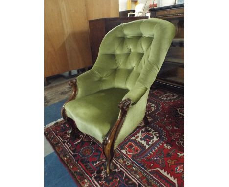 A Victorian Mahogany Framed Button Upholstered Ladies Armchair on Scrolled Cabriole Front Legs.