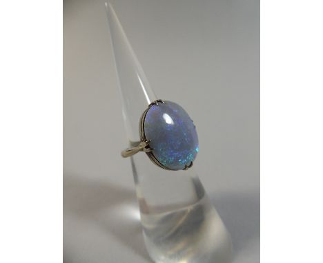 A Large Natural Blue Opal Ring Set in 9ct White Gold. Opal with Intense Green and Blue Colour Play. Opal 17.5x14mm. Total Wei