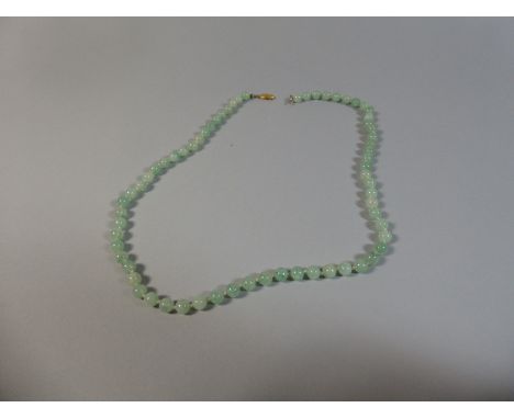 A String of Jade Beads. 66cm Long